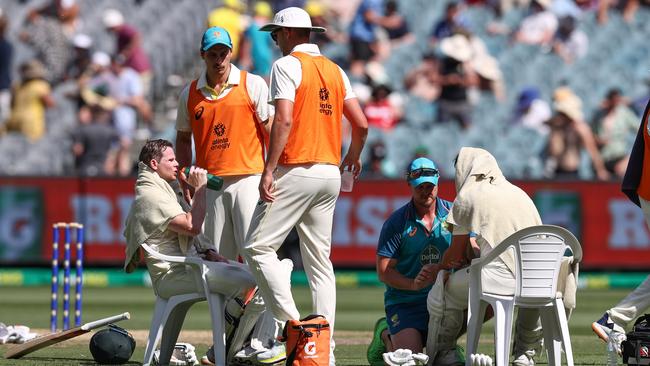 Steve Smith (L) and David Warner battle the conditions during a drinks break. Picture: Michael Klein