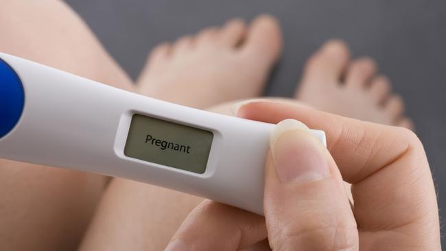 THINKSTOCK - Woman taking a pregnancy test showing pregnant result