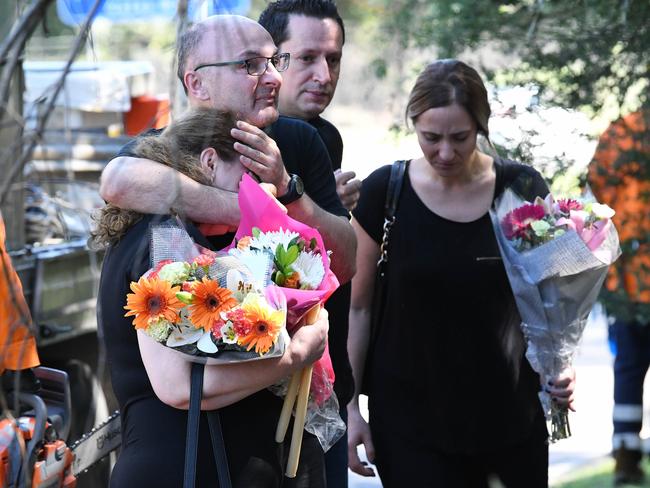 Family and friends arriving yesterday to lay floral tributes at the Port Botany scene. Picture: Simon Bullard.