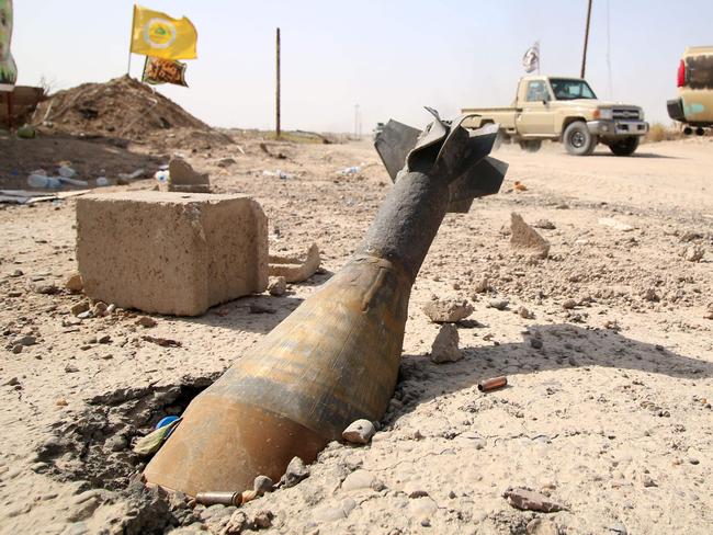 An unexploded mortar shell is seen half buried in the ground in Fallujah. Picture: Haidar Mohammed Ali