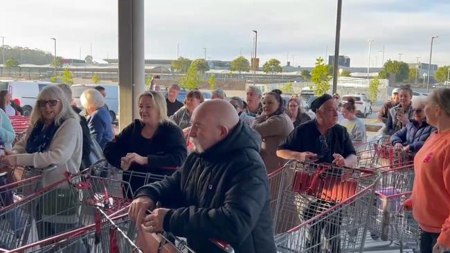 Crowds of shoppers outside waiting to get in.