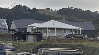 The original home in the foreground, with the extension at the back.