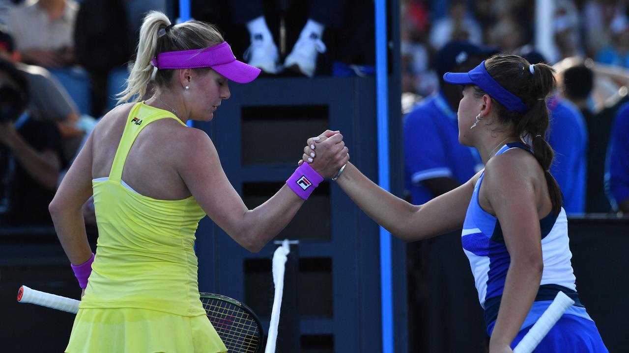 Ukraine's Kateryna Baindl (L) embraces Russia's Kamilla Rakhimova (R) after winning her opening match. (Photo by Paul CROCK / AFP)