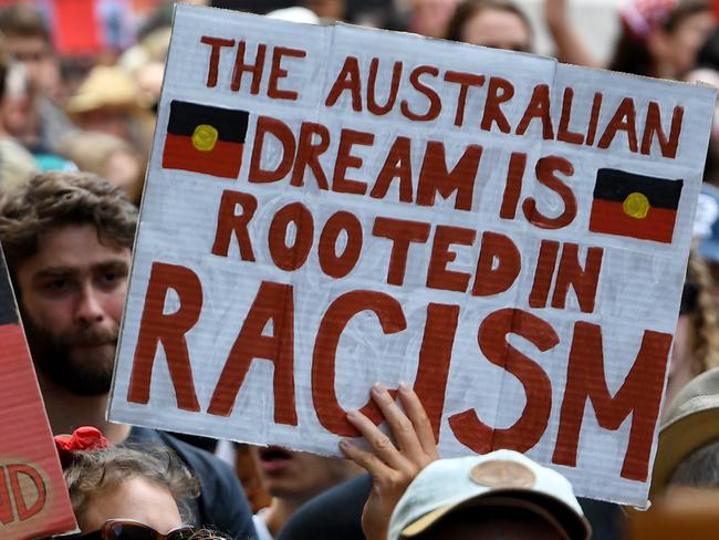 Protesters are seen during the Invasion Day rally in Melbourne, Sunday, January 26, 2020. (AAP Image/James Ross) NO ARCHIVING