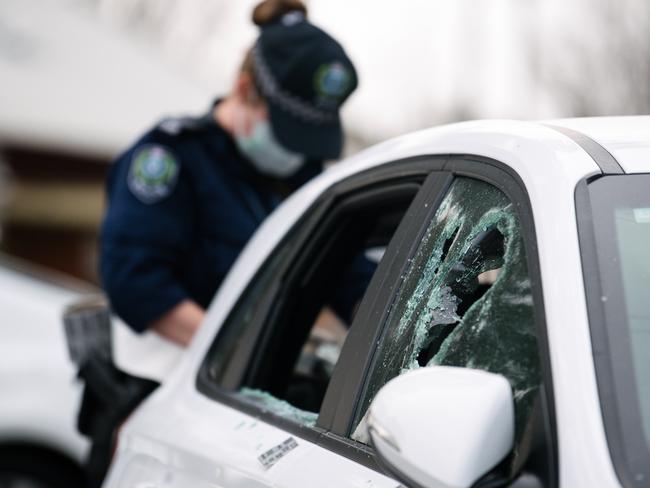 Police are seen with damaged cars in the Department for Child Protection parking lot in Marion, in Adelaide, Friday, July 12, 2019. (AAP Image/ Morgan Sette)