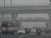 (FILES) In this file photo taken on November 5, 2021, commuters make their way along a street amid smoggy conditions in New Delhi. - Even as its capital was blanketed by toxic smog, India led the charge to weaken anti-coal pledges at the COP26 summit, with experts saying it is prioritising its economic growth over the planet's future. (Photo by Prakash SINGH / AFP) / TO GO WITH India-Environment-climate-coal,FOCUS by Abhaya SRIVASTAVA