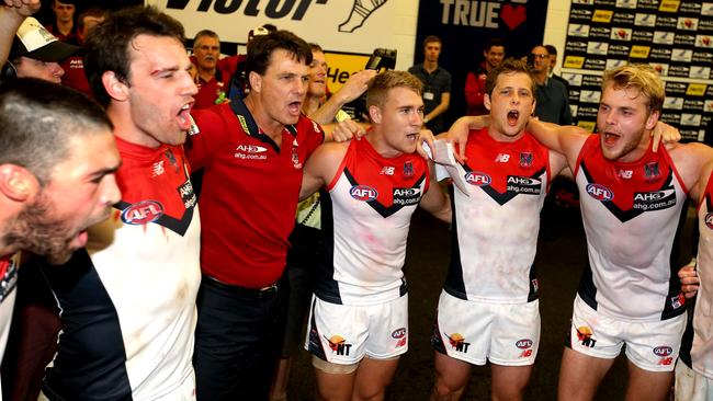 Paul Roos belts out the Dees club song with his players. Picture: Wayne Ludbey