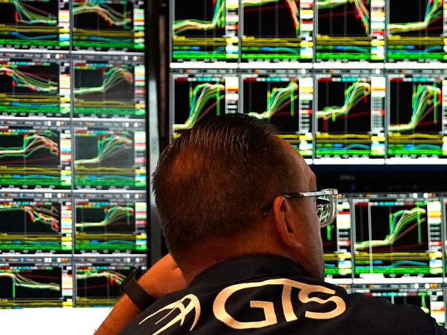 Traders work on the floor of the New York Stock Exchange (NYSE) at the opening bell on November 6, 2024, in New York City. Wall Street stocks surged in opening trading on Wall Street Wednesday after US voters sent Donald Trump back to the White House and delivered him a Republican Senate. Major indices were up 1.8 percent or more in the early going as hopes about expected tax cuts and regulatory easing more than offset worries about higher tariffs. (Photo by TIMOTHY A. CLARY / AFP)