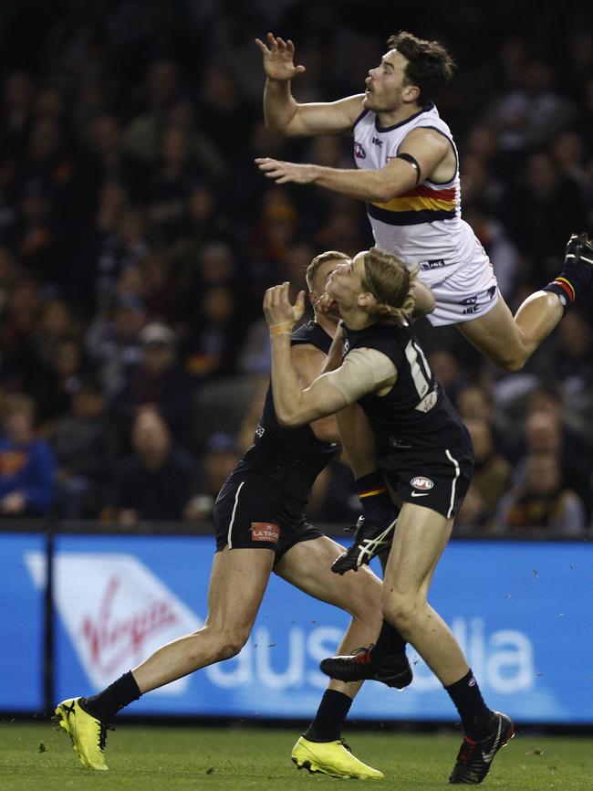 Crows Mitch McGovern  flies for a mark against Carlton at Etihad Stadium.