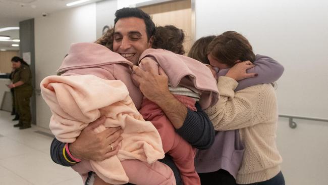 Yoni Asher welcomes his four-year-old daughter Raz who was snatched with her two-year-old sister Aviv and their mother Doron by Hamas during the October 7 attack, upon their arrival at a hospital in Israel, following their release. Picture: AFP PHOTO / ISRAELI ARMY