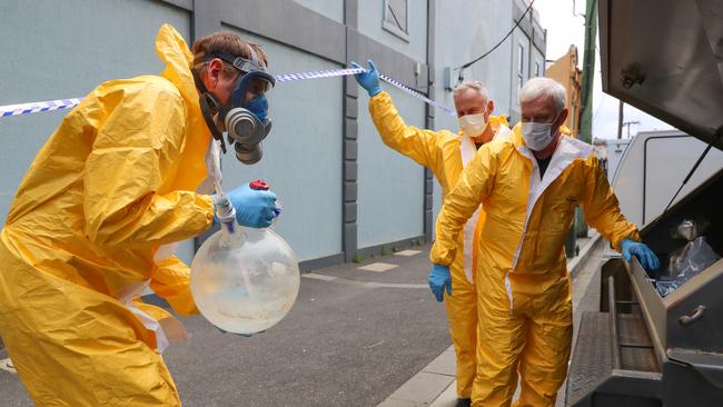 Evidence being collected and taken from the lab. Picture: Alex Coppel.