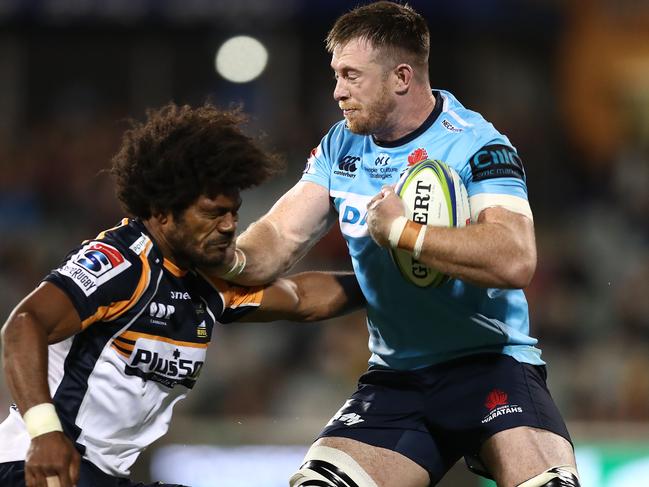 Jack Dempsey of the Waratahs is tackled by Henry Speight on Friday night.