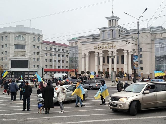 People hold Ukrainian flags as they gather to celebrate the liberation of their town in Kherson, amid Russia's invasion of Ukraine. Picture: AFP