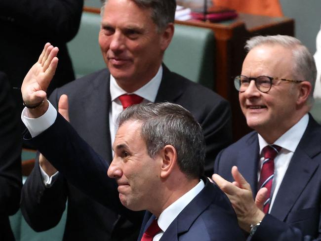 Australian Treasurer Jim Chalmers waves after his fourth Federal budget speech as Prime Minister Anthony Albanese (R) applauds in the House of Representatives at the Parliament House in Canberra on March 25, 2025. (Photo by David GRAY / AFP)