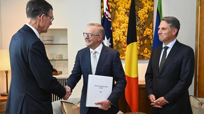 Sir Angus Houston delivers the Defence Strategic Review 2023 to Prime Minister Anthony Albanese and Deputy PM and Minister of Defence Richard Marles at Parliament House on February 14, 2023. Picture: Martin Ollman/Getty Images