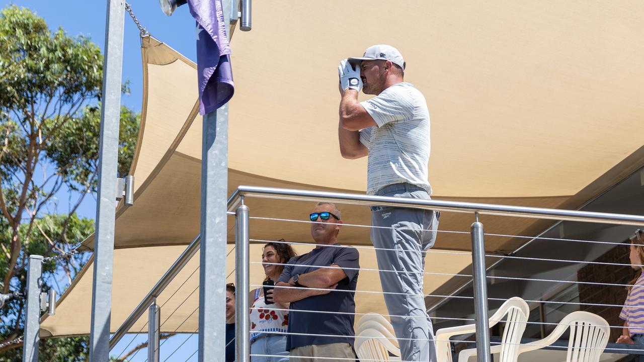 Bryson DeChambeau reads yardage from a balcony of a house next to the 13th hole at Grange Golf Club on Saturday (Photo by Jon Ferrey/LIV Golf)
