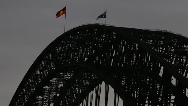 The Aboriginal flag is seen alongside the Australian flag on top of the Harbour Bridge Lisa Maree Williams/Getty Images