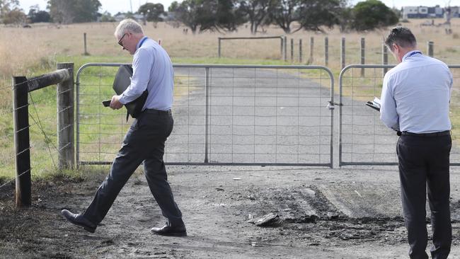 Detectives at the scene of the fire. Picture: David Crosling