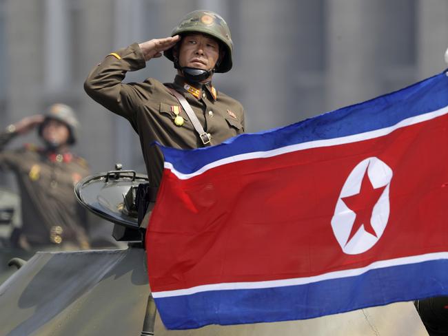 A North Korean national flag flutters as soldiers in tanks salute to North Korean leader Kim Jong Un during a military parade in Pyongyang, North Korea. Picture: AP