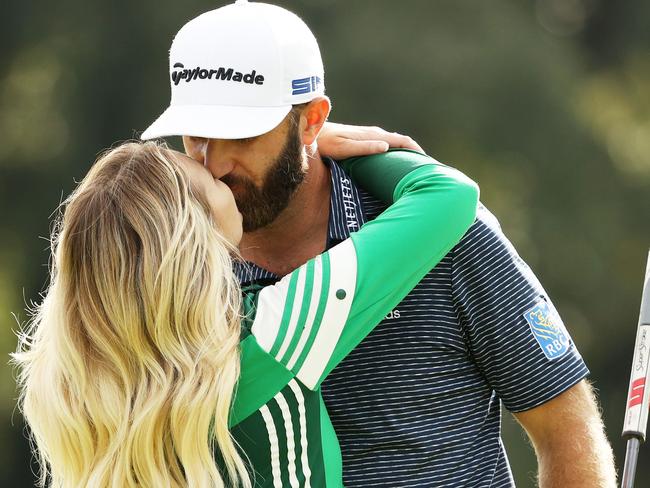 Dustin Johnson kisses fiancee Paulina Gretzky after winning the Masters.