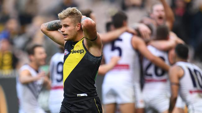 Brandon Ellis can’t believe the Tigers lost as Fremantle players celebrate in the background. Picture: AAP