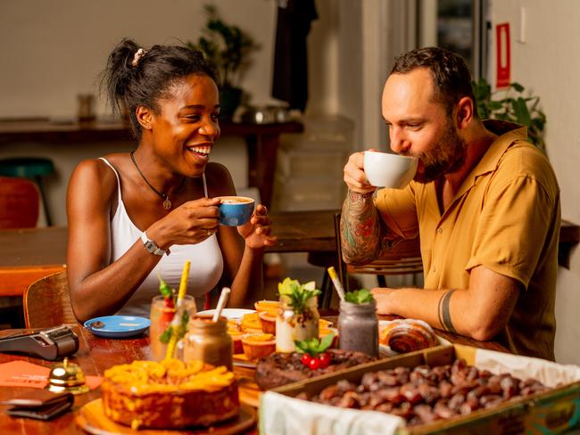 Rebecca Larendu Mbonga and Kuba Mach enjoy a coffee at the Lucky Bat, Nightcliff. The Lucky Bat Cafe owners have registered for the Darwin City Council's voucher program which will put $300,000 back into the local economy.Picture: Che Chorley