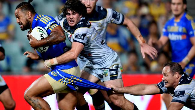 Kenneth Edwards of the Parramatta Eels on the run is tackled by Jake Granville and Matthew Scott of the North Queensland Cowboys during their round 2 NRL match between the Parramatta Eels and the North Queensland Cowboys at Pirtek Stadium in Parramatta Sydney, Saturday, March 12, 2016. (AAP Image/Brendan Esposito) NO ARCHIVING, EDITORIAL USE ONLY