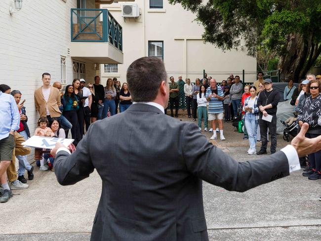 DAILY TELEGRAPH. Property. Auctioneer Chris Scerri takes bids for 8/1 Chandos Street in Ashfield, a 3 bedroom apartment in a historic former hospital building. Saturday 02/11/2024. Picture by Max Mason-Hubers