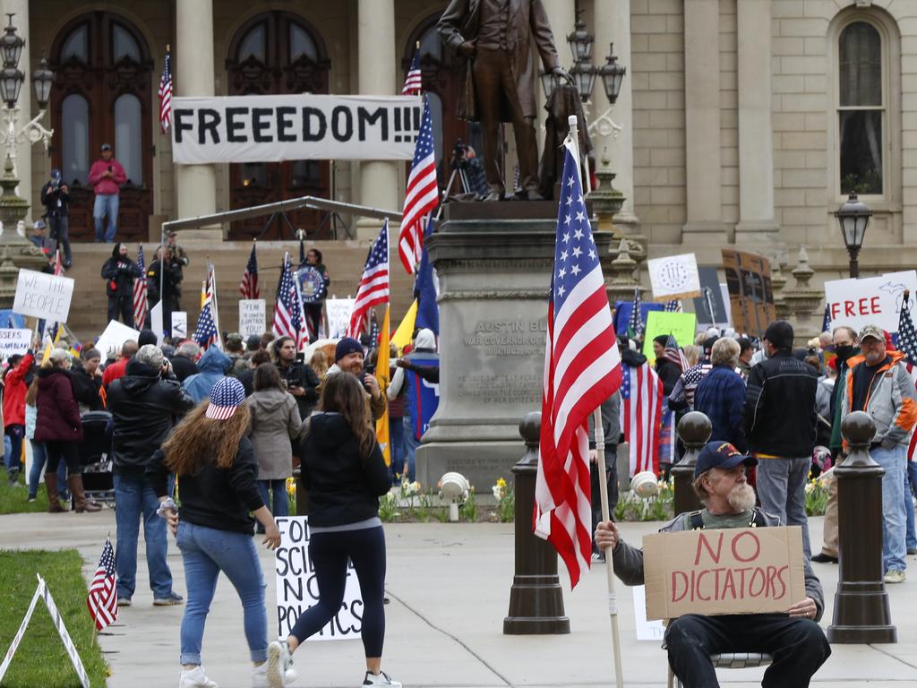 Protesters rally at the State Capitol in Lansing, Michigan this week. Gun-carrying protesters have been a common sight at some demonstrations calling for coronavirus-related restrictions to be lifted. Picture: AP/Paul Sancya