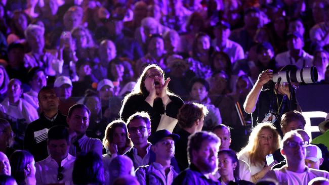 A protester shouts about domestic violence allegations during the trophy ceremony. Picture: Martin Keep / AFP