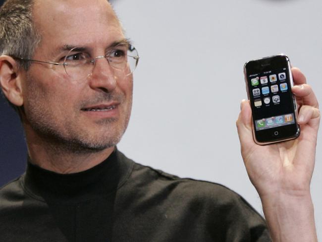 First generation ... Apple CEO Steve Jobs holds up an Apple iPhone at the MacWorld Conference in San Francisco in 2007. Picture: AP