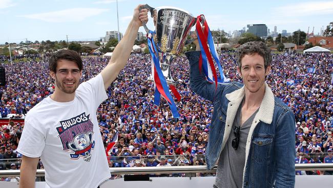 Easton Wood and Bob Murphy raise the premiership cup in front of thousands of Bulldogs fans at Whitten Oval. Picture: Michael Klein