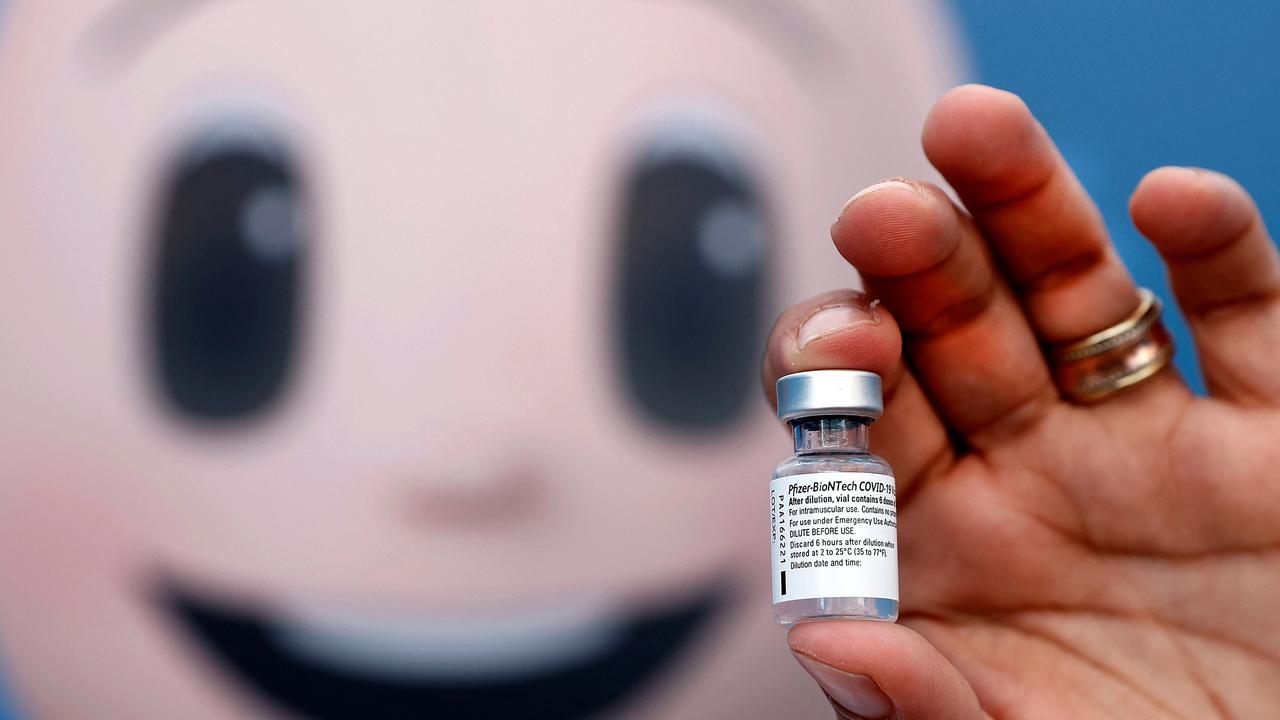 A medic holding up a vial of the Pfizer-BioNTech Covid-19 coronavirus vaccine.