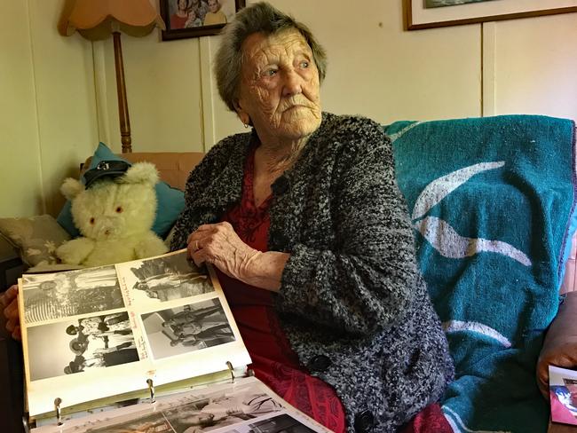 Beryl Hughes looking through some old photos at her Killcare home. Picture: Cathy Stubbs.