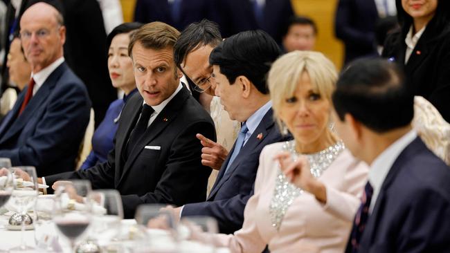 Vietnam's President Luong Cuong and his French counterpart Emmanuel Macron attend a state dinner with their respective wives Nguyen Thi Minh Nguyet and Brigitte Macron at the International Convention Center in Hanoi. Picture: AFP