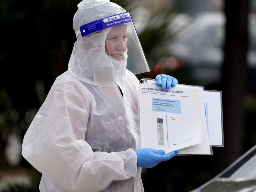 Pharmacist Mary Reamer holds up instructions at a self-collection COVID-19 testing site in Houston. Picture: David J. Phillip/AP Photo