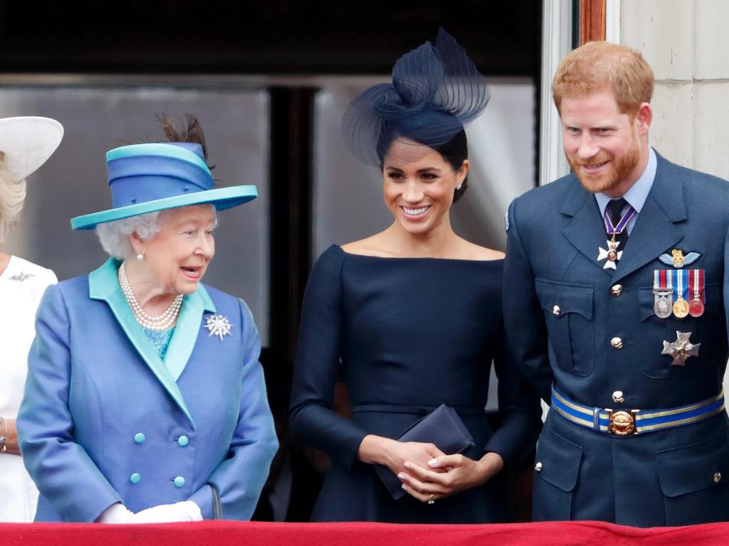 Meghan Markle and Prince Harry, with the late Queen Elizabeth II on the balcony of Buckingham Palace in July 2018, have long been accused of bullying staff. Picture: Getty Images