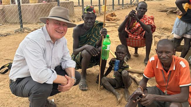 Michael McCormack talks to locals who have come to a water bore in drought-stricken Turkana County. Picture: Ellen Whinnett