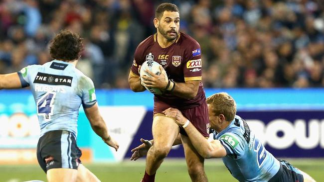 Greg Inglis runs the ball for the Maroons against the Blues at the MCG.