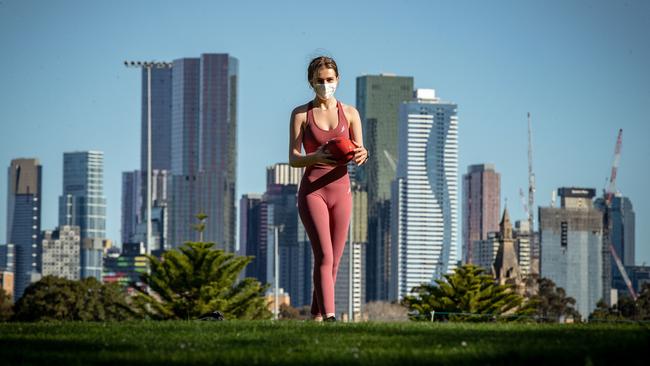 A woman plays football in the afternoon sun at Princes Park in Carlton on Sunday. Picture: Getty Images