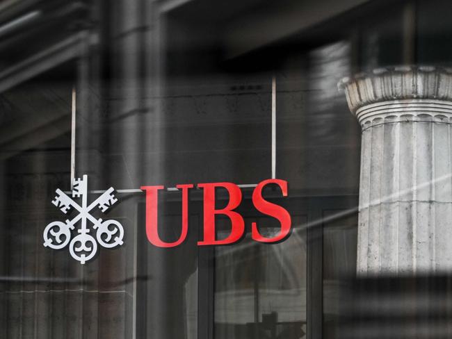 A sign and logo of the Swiss giant banking UBS is seen in Lausanne on February 6, 2024. Swiss banking giant UBS said on February 6, 2024 it would hand shareholders up to 1 billion US dollars in share buybacks as it posted a smaller-than-expected quarterly loss stemming from the costs of absorbing fallen rival Credit Suisse. (Photo by Fabrice COFFRINI / AFP)