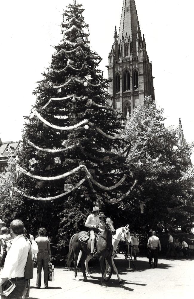 Horsemen carry a message to the Bendigo Lord Mayor from the Melbourne Lord Mayor with the City Square Christmas tree in the background in 1983. 