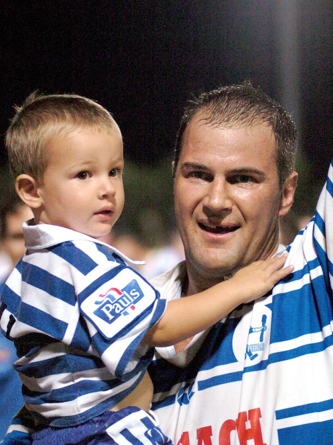 Brothers captain Brad Arthur with son Jacob, 2, celebrates winning the 2004 grand final.