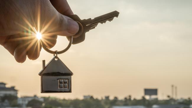 House model and key in home insurance broker agent  hand or in salesman person. Real estate agent offer house, property insurance and security, affordable housing concepts. Property investing, investment. Source: istock - for Herald Sun realestate