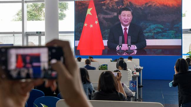 Journalists watch Xi Jinping delivering a speech during the opening of the Bo'ao Forum for Asia. Picture: AFP.