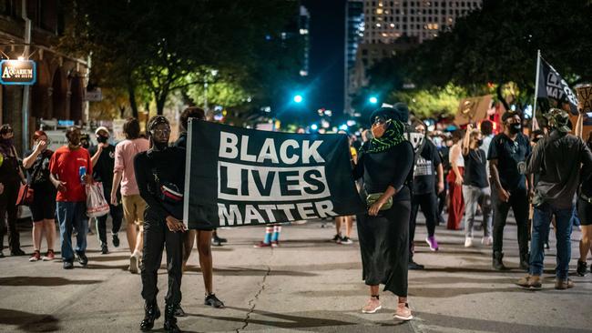 People march in the street after a vigil for Garrett Foster, who was shot and killed after an altercation with a motorist at a protest in Texas. Picture: Sergio Flores/AFP