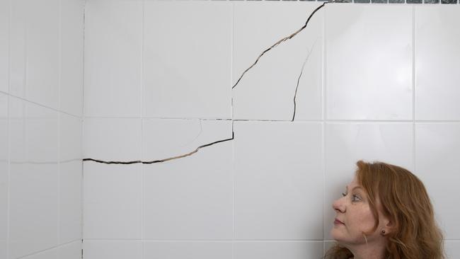 North Strathfield resident Stephanie Dennett with a crack in her bathroom she says was caused by WestConnex tunnelling. Picture: Quentin Jones