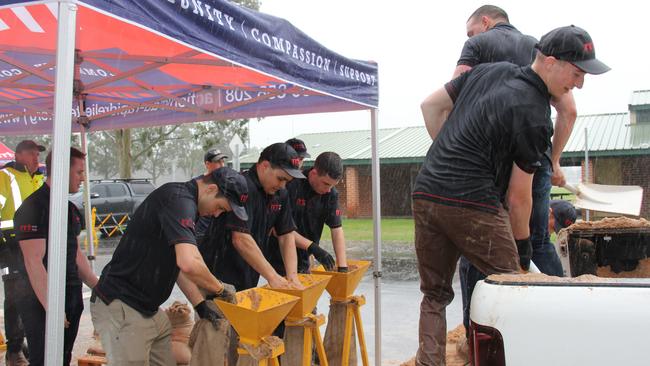 Volunteer workers from Rapid Relief Team frantically fill sandbags at Jamison Park, Penrith as the region experiences its worst flooding event since 1961. Picture: Supplied