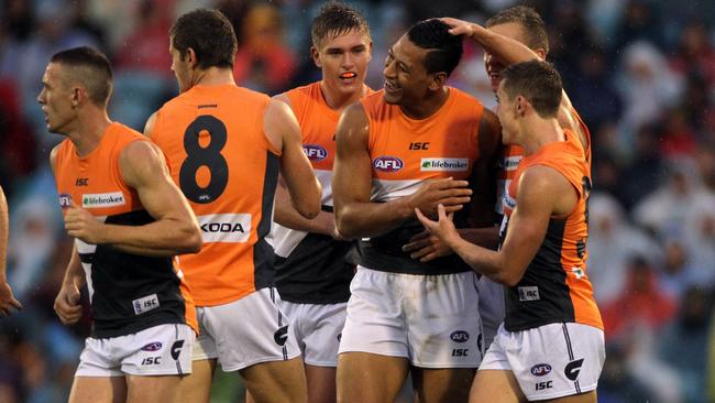 GWS players celebrate a goal with rugby convert Israel Folau. Picture: Simon Cross.