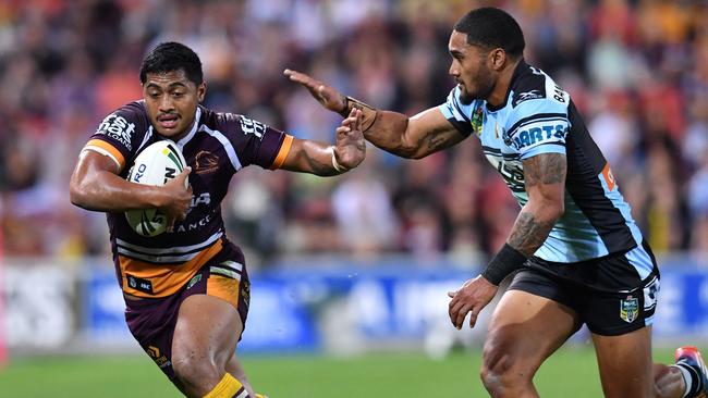 Broncos five-eighth Anthony Milford gets past Sharks centre Ricky Leutele.